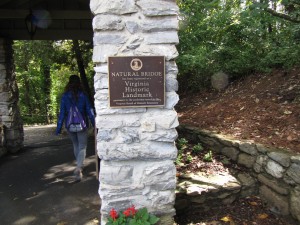a plaque on a white stone pillar noting that Natural Bridge is a Virginia Historic Landmark