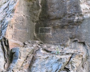 rock face with initials G.W. carved into it, boxed in with white paint