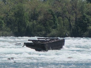 a portion of a barge in rushing water