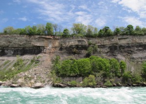 rushing water with cliffs across the river