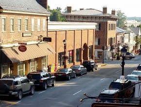 downtown area with brick buildings and cars lining the street