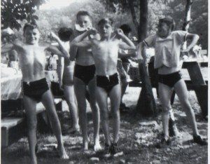 young boys in swimsuits flexing muscles