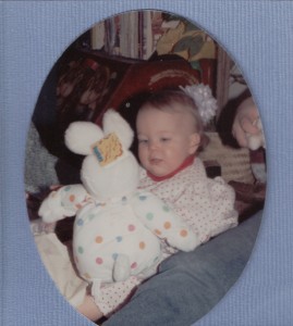 baby looking at largestuffed rabbit in polka dot suit