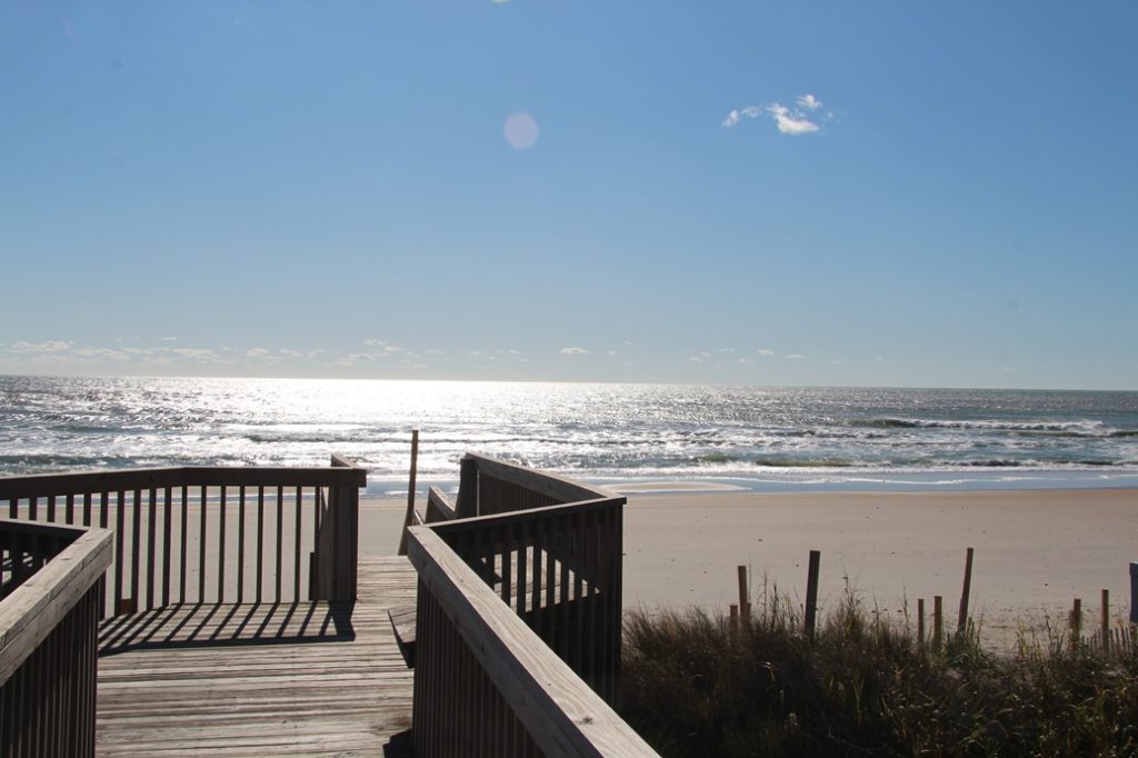 a wooden walkway to the beach