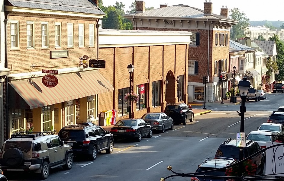 downtown area with brick buildings and cars lining the street